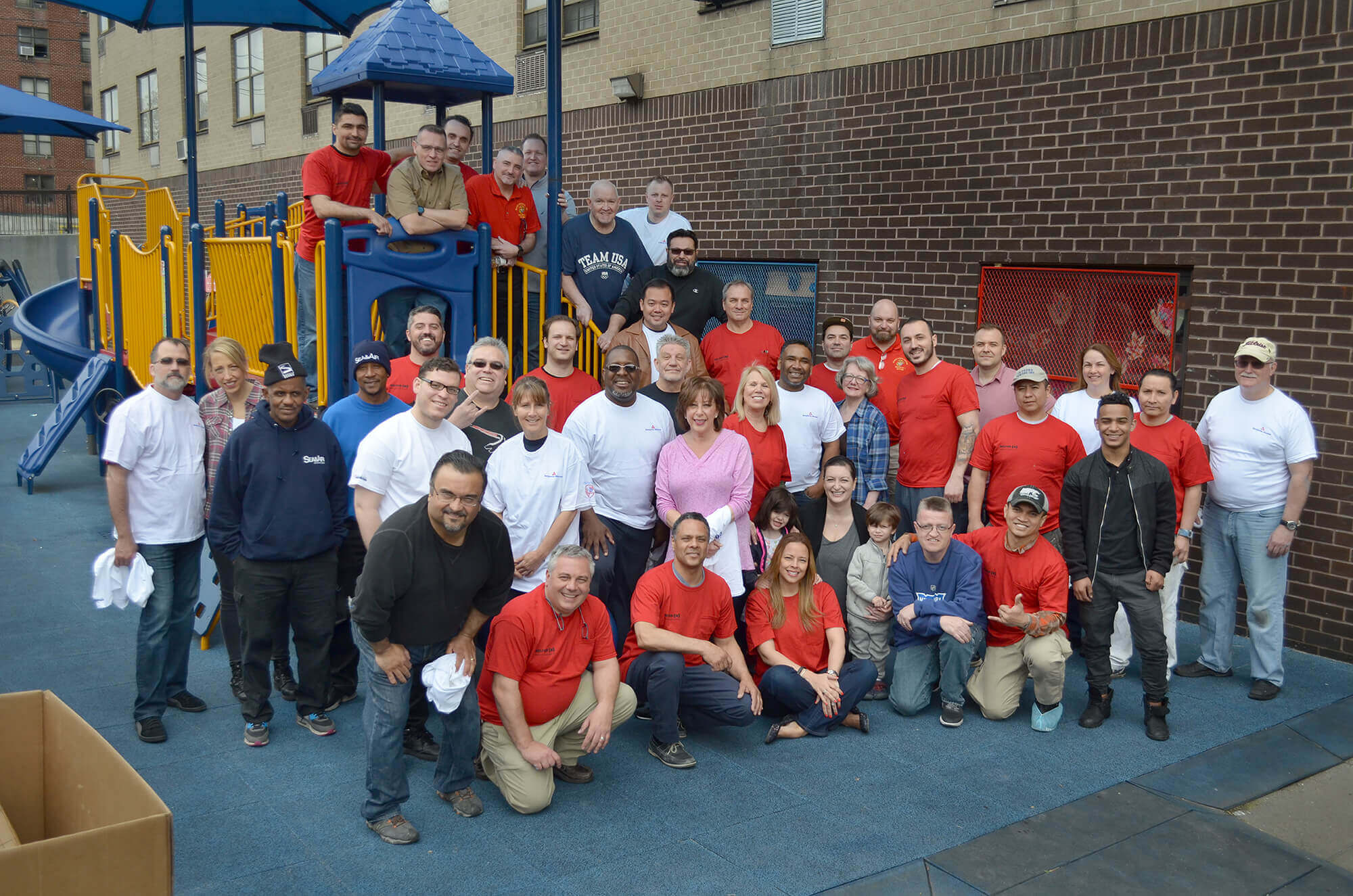 The team gathers for a group photo after renovating Astoria Blue Feather Early Learning Center